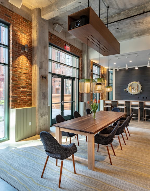 A dining room with a wooden table and chairs.