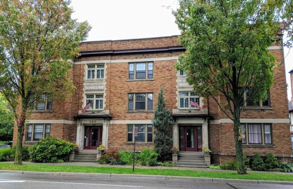 a red brick building with two american flags in front of it