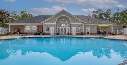 A pool in front of a house.