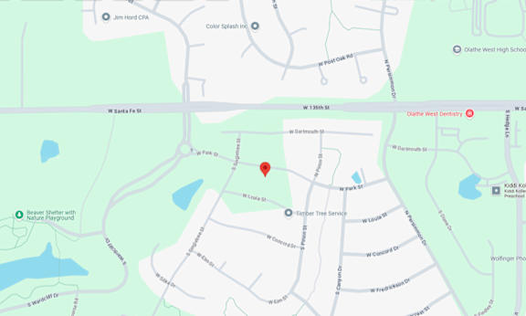 A map shows a red pin marking a specific location near a body of water.