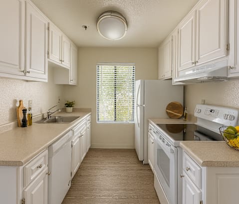 A kitchen with white cabinets and appliances.at Camino Creek, California, 94928