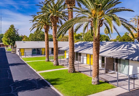 a row of houses with palm trees in front of them