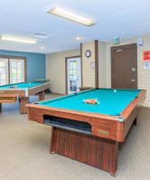 a games room with two pool tables and a foosball table