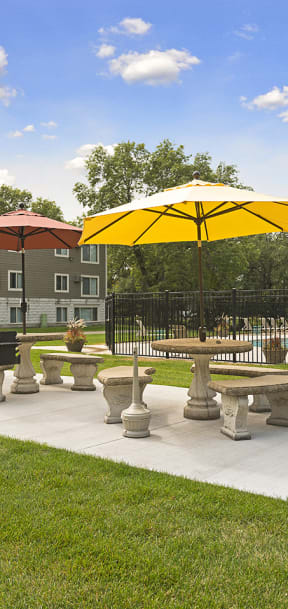 A sunny day at the park with tables and umbrellas. at Minnehaha Manor, Oakdale, 55128