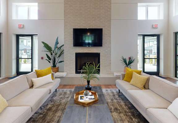 a living room with couches and a coffee table at The Fitzroy San Marcos, San Marcos, TX