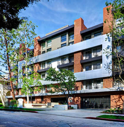 A modern multi-story building with balconies and large windows at El Greco Lofts, California
