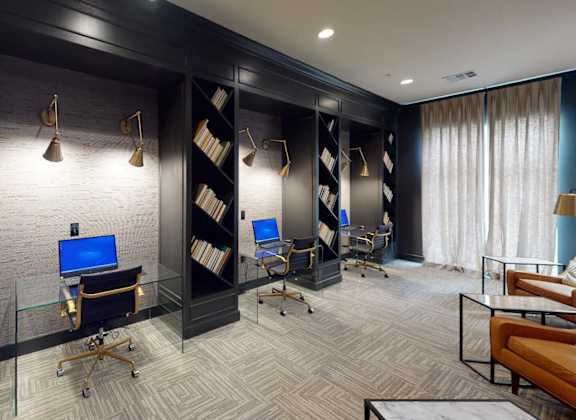a conference room with desks and chairs and a window