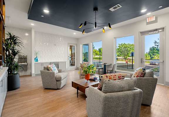 a living room with couches and chairs and a table