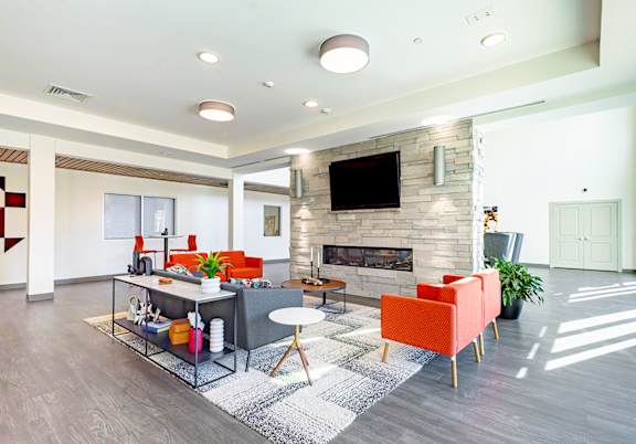 A modern living room with a fireplace and a television.