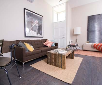 A living room with a brown couch and a coffee table.