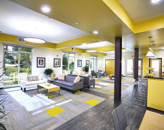 a living room with a kitchen and a balcony