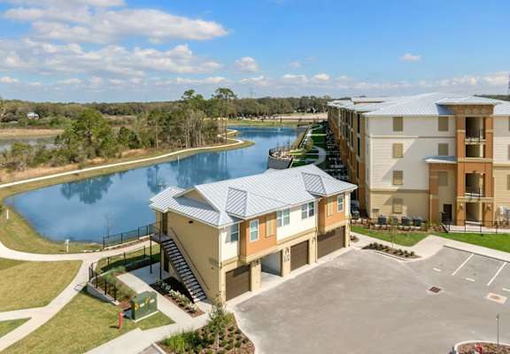 an aerial view of an apartment complex with a lake