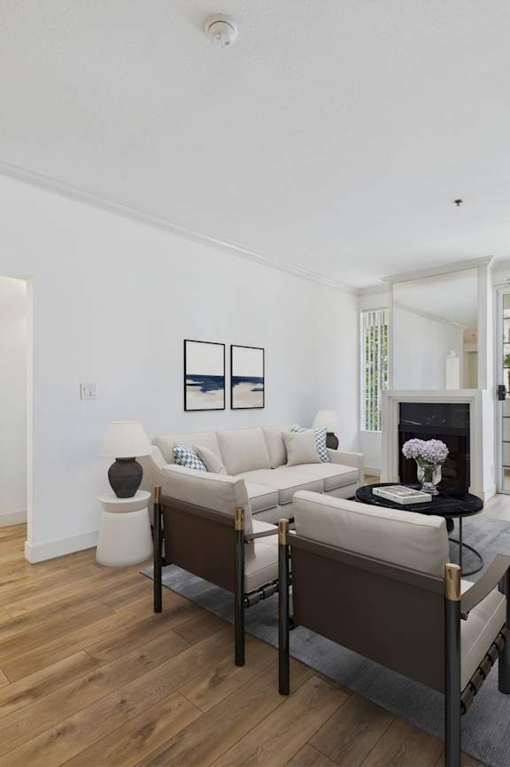 A living room with a white couch and a black chair.