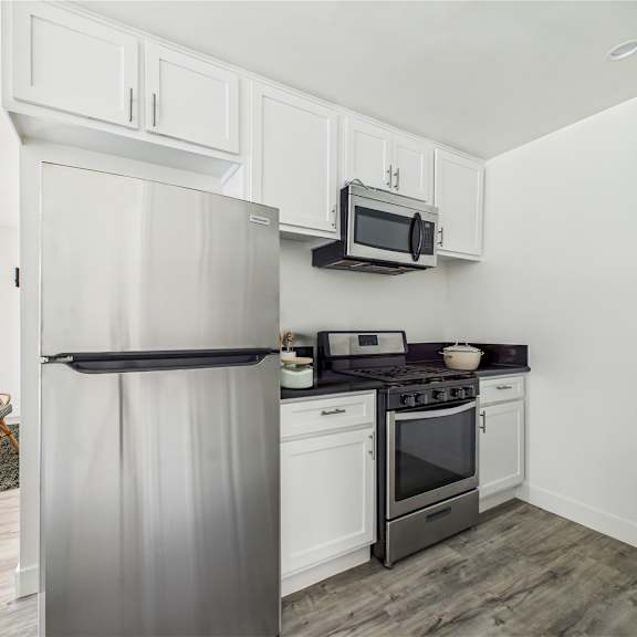 A modern kitchen with a stainless steel refrigerator.