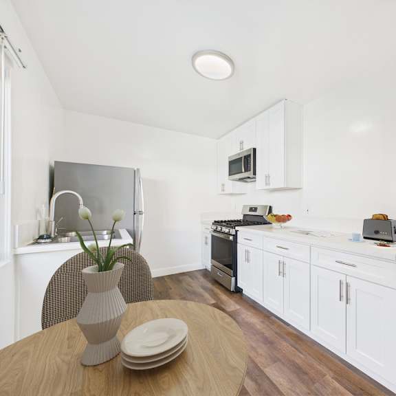 A modern kitchen with a stainless steel refrigerator.