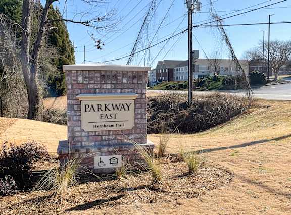 a sign for shell pointe apartments in front of a brick wall