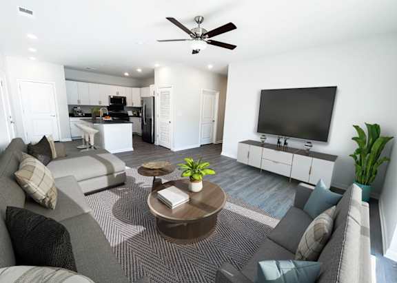 a kitchen with gray and white cabinets and a counter with three bar stools
