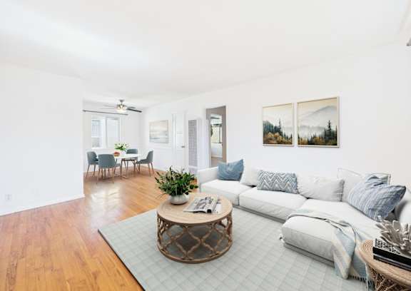 A living room with a white couch and a coffee table.