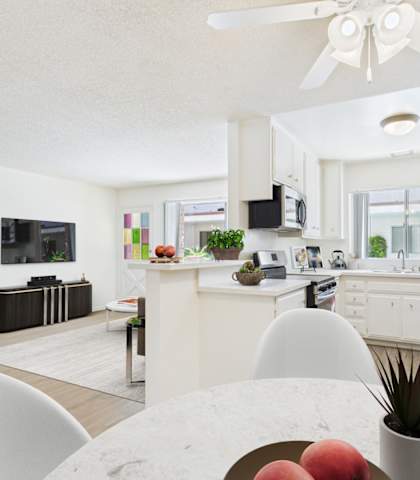 A modern kitchen with a dining table and chairs in the foreground.