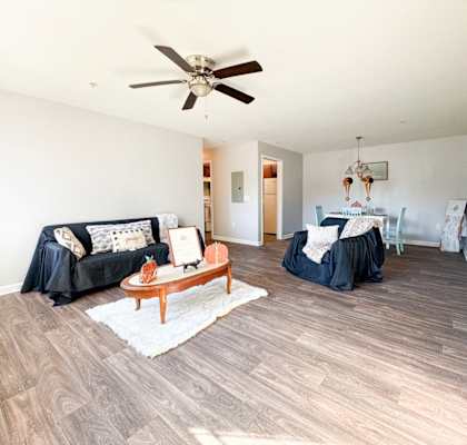 a living room with a ceiling fan and a couch