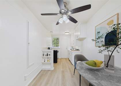A modern kitchen with a dining table and chairs.