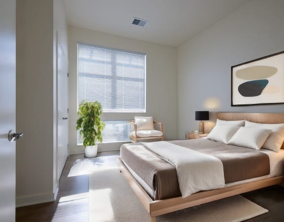 a bedroom with a bed with pillows and two lamps