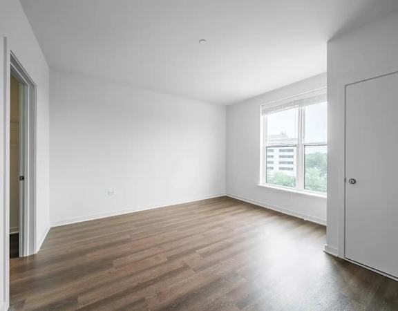 A room with wooden floors and white walls.