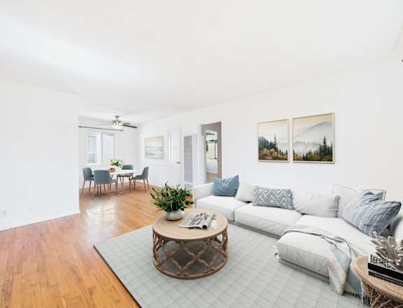 A living room with a white couch and a coffee table.
