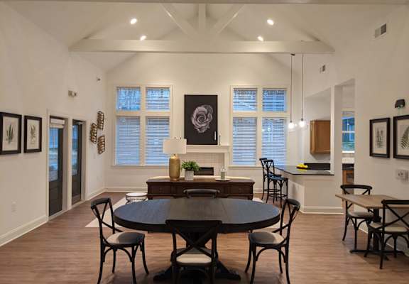 a dining room and living room with a table and chairs