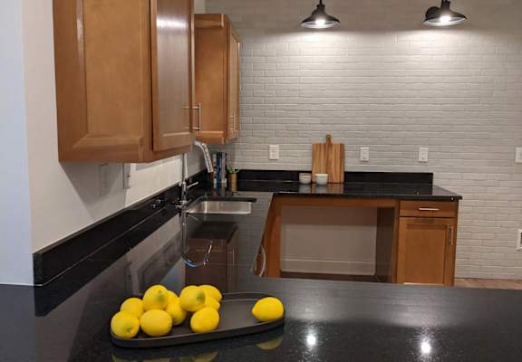 a kitchen with a tray of lemons on the counter