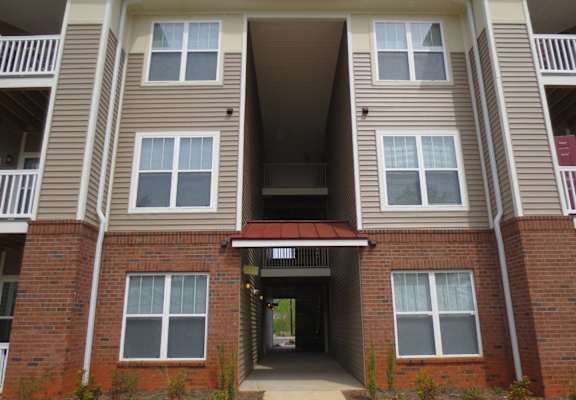 the outside of an apartment building with a walkway
