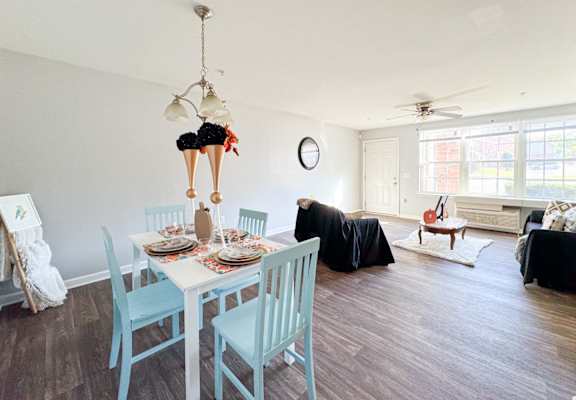 a dining room and living room with a table and chairs