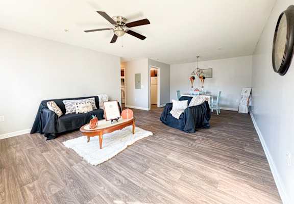 a living room with a ceiling fan and a couch