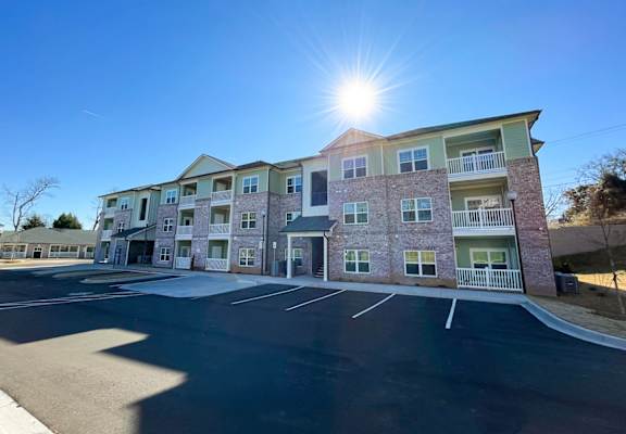 A sunny day at a multi-story apartment complex.