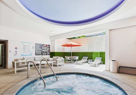 A round pool with a hot tub in the middle of it.