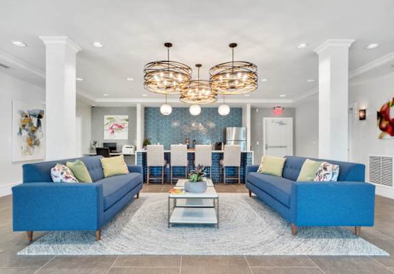 a living room with couches and chairs and a table
