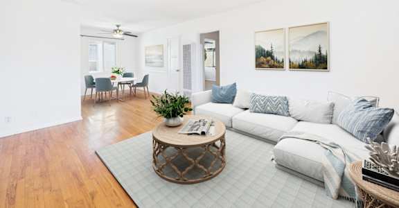 A living room with a white couch and a coffee table.
