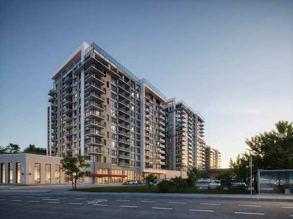 A modern apartment building with a parking lot in front.