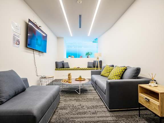 a living room with couches and a tv