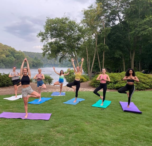a group of women doing yoga on the lawn