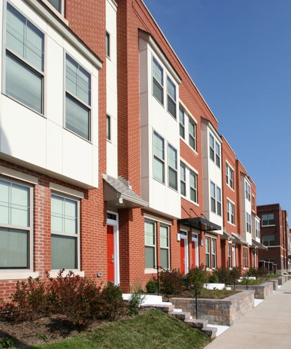 a row of townhouses on the side of a street