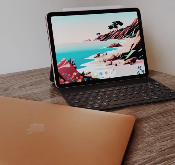 a laptop computer sitting on top of a wooden desk