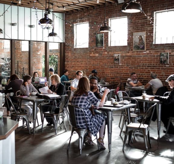 people sitting at tables in a restaurant