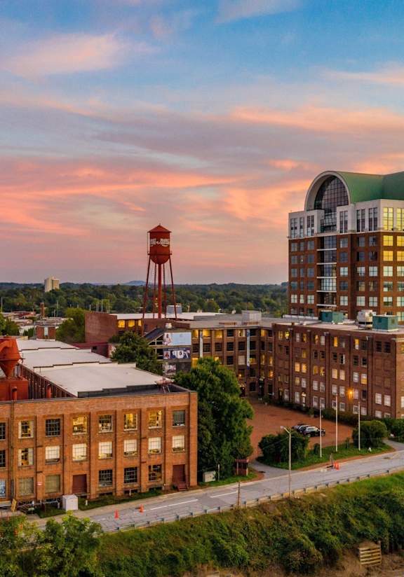 A large building with a red water tower in the background.