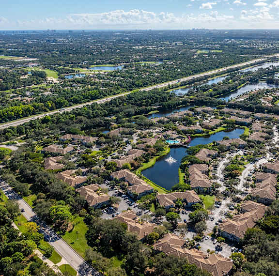 A bird's eye view of a residential area with a river running through it.