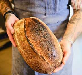 A person holding a loaf at Bautista Apartments, Tucson, AZ, 85745