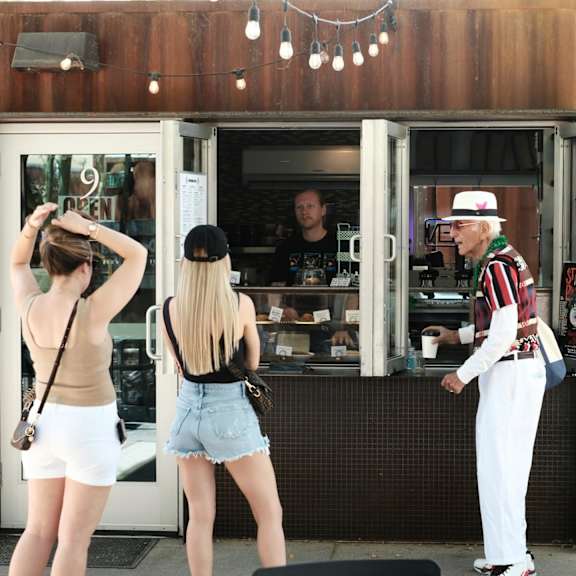 Two women are standing outside a cafe at Bautista Apartments, Tucson, AZ, 85745