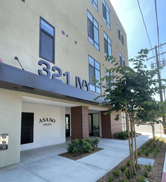 the front of a building with a sidewalk in front of it