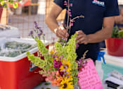 Thumbnail 42 of 46 - A man is arranging flowers at Bautista Apartments, Arizona