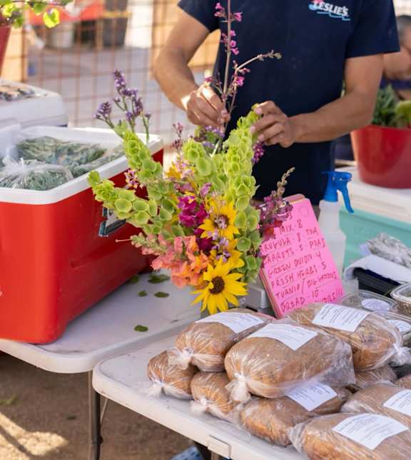 A man is arranging flowers at Bautista Apartments, Arizona
